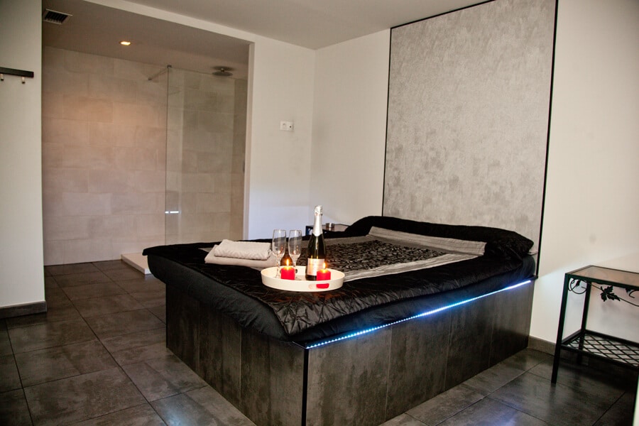 Suite with designer bed and bathroom in a brothel in Malaga