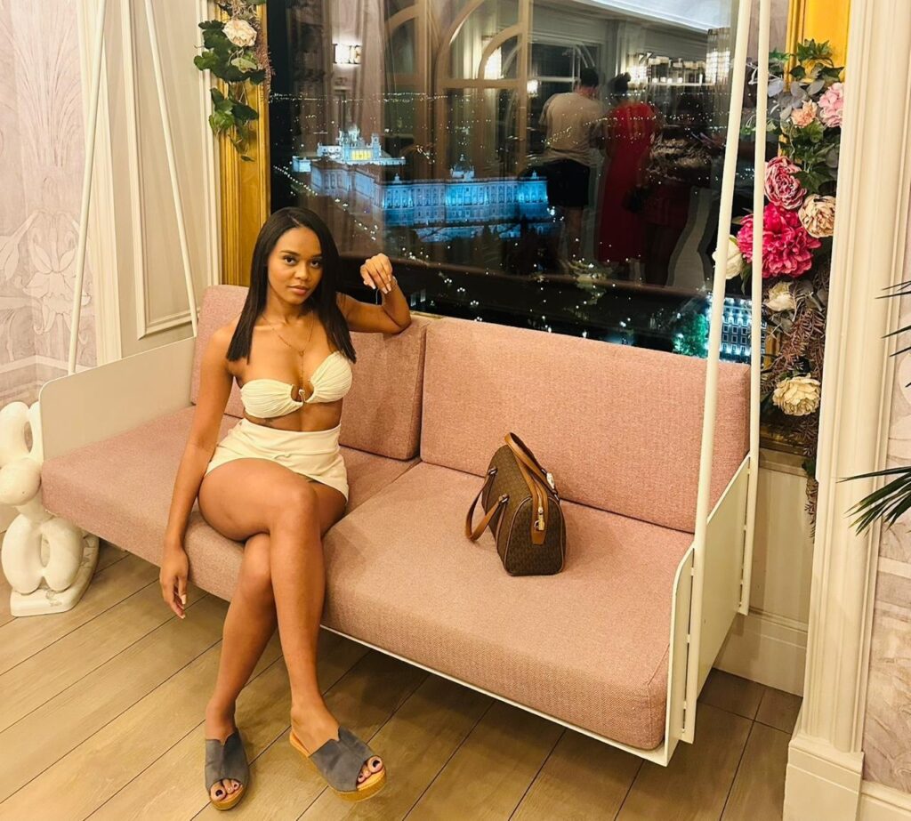 Alison, an escort, poses while sitting on a sofa in a restaurant in Malaga