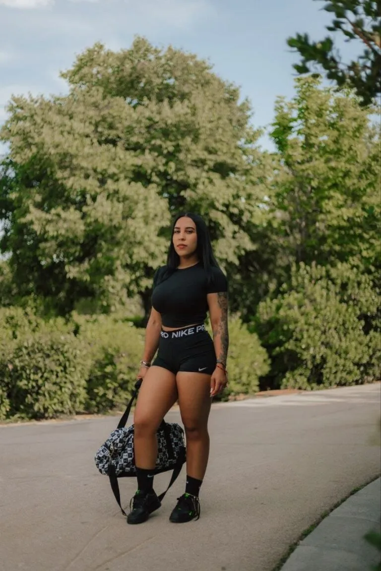 Nicol, escort wears t-shirt, nike shorts, black socks and black sneakers in Malaga
